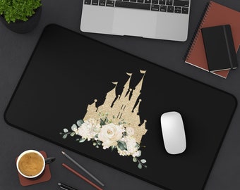 May include: Black mouse pad with a gold glitter castle silhouette and white floral design. The castle is a popular theme park attraction.
