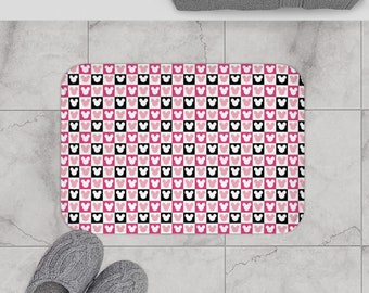 May include: Pink and black checkered bath mat with a white Mickey Mouse head pattern.