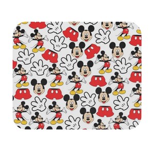 May include: A white background with a repeating pattern of Mickey Mouse, his red shorts, and his white gloves.