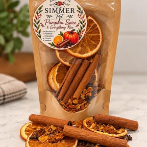 May include: A resealable kraft paper pouch containing a pumpkin spice simmer pot mix, featuring dried orange slices, cinnamon sticks, and cloves. The circular label reads Rose & Vine Naturals Simmer Pot Pumpkin Spice & Everything Nice.