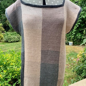 May include: A knitted top with a striped pattern in shades of gray, pink, and beige. The top has a scoop neck and short sleeves.