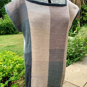 May include: A striped knit top with a square neckline and short sleeves. The top is made in shades of brown, gray, and blue.