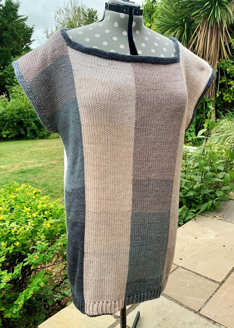 May include: A striped knit top with a square neckline and short sleeves. The top is made in shades of brown, gray, and blue.