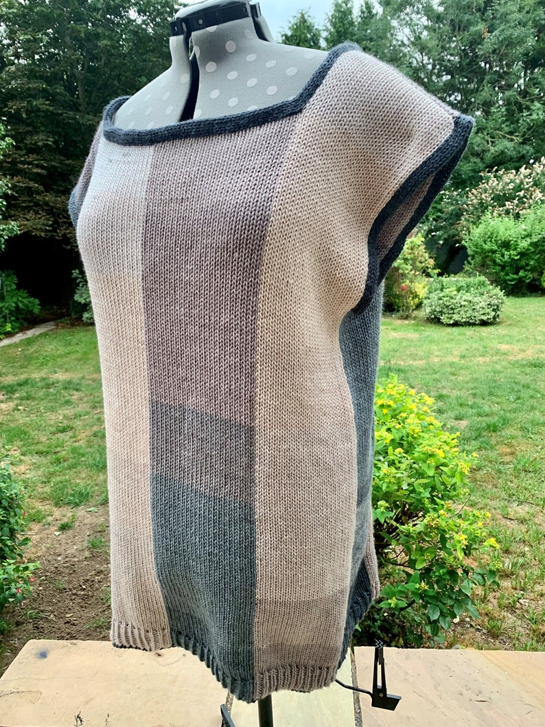 May include: A striped knit top with a square neckline and short sleeves. The top is made of a soft, textured yarn in shades of brown, gray, and beige.