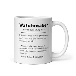 May include: White ceramic mug with a black and white definition of the word "Watchmaker" with the pronunciation "(woch-may-kuh)" and two definitions. The mug has a black handle.