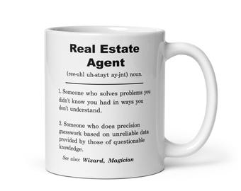 May include: White ceramic coffee mug with a black and white design that defines a real estate agent as someone who solves problems you didn't know you had in ways you don't understand. The mug also says "See also: Wizard, Magician".