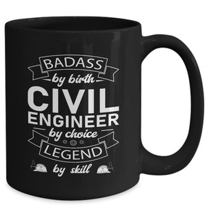 May include: Black ceramic coffee mug with white text that reads "Badass by birth, Civil Engineer by choice, Legend by skill". The mug has a white graphic of a hard hat and a compass.