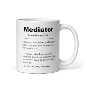 May include: White ceramic mug with a black and white definition of the word "Mediator" with the phonetic pronunciation and two definitions. The mug has a black handle.