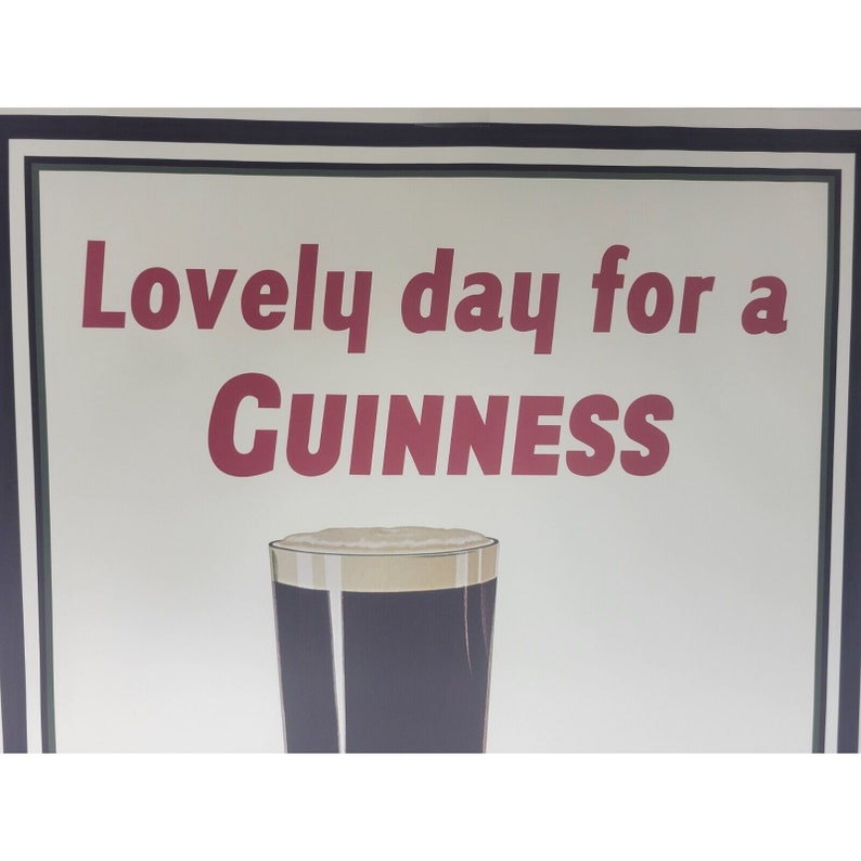 May include: A vintage Guinness advertisement featuring a glass of dark beer with a white head. The text reads "Lovely day for a GUINNESS".