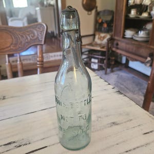 Antique bail light green glass bottle with sealed top