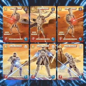 Può includere: Sei carte da gioco rettangolari con personaggi di Star Wars. La fila superiore mostra tre carte droide da battaglia beige con effetti laser rossi. La fila inferiore mostra tre carte clone trooper bianche e blu con effetti laser blu su sfondo arancione.
