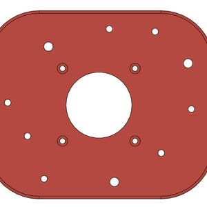 May include: A red metal plate with a large circular cutout in the center and multiple smaller holes around the edge.