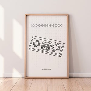 Puede incluir: Una ilustración en blanco y negro de un mando de videojuego clásico con el código Konami impreso encima. El texto "KONAMI CODE" está impreso debajo del mando.