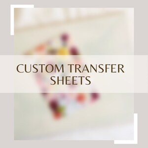 May include: Custom transfer sheets for crafting projects. The sheets are white and have a blurred image of colorful flowers in the background.