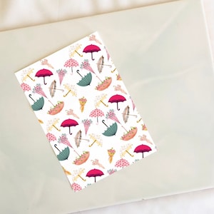 May include: A white background with a repeating pattern of pink and green umbrellas, bouquets of flowers, and gold handles.