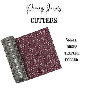May include: A metal texture roller with a pattern of small roses. The roller is unfurling to reveal the pattern it creates. The text "SMALL ROSES TEXTURE ROLLER" is visible on the right side of the image.
