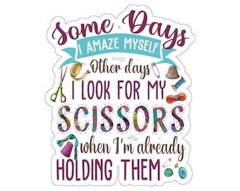 Może przedstawiać: Kolorowa naklejka z tekstem "Some Days I Amaze Myself Other days I Look For My Scissors When I'm Already Holding Them". Naklejka przedstawia różne narzędzia do szycia i rękodzieła, w tym nożyczki, naparstek, miarę krawiecką i szpilkę.