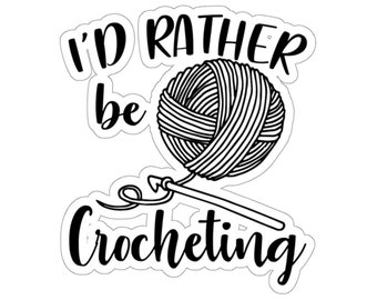 May include: Black and white illustration of a ball of yarn and a crochet hook with the text "I'd rather be crocheting".