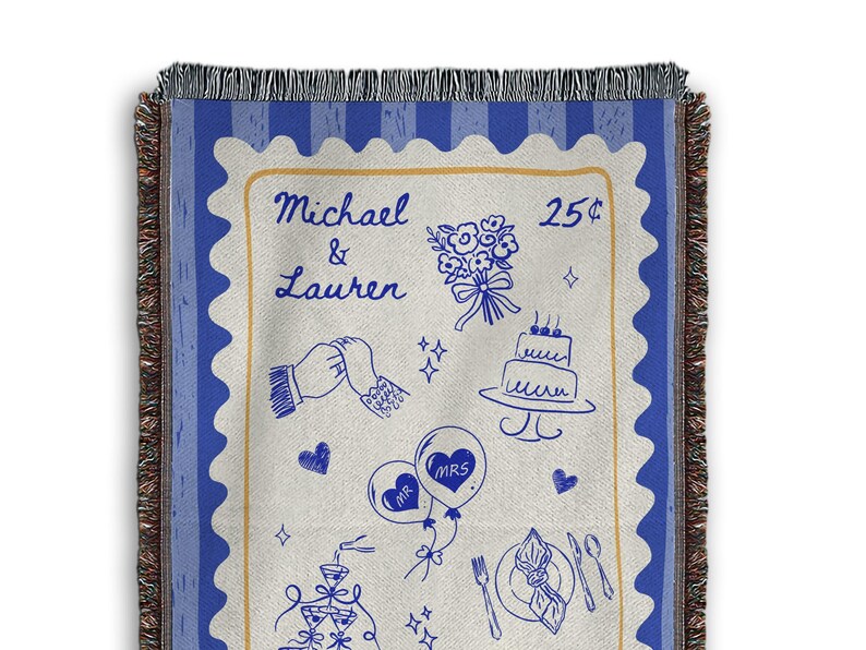 May include: A woven throw blanket with a blue and cream design. The centre features a stamp-like illustration with wedding-themed drawings and the names "Michael & Lauren." The border is blue with a fringed edge.