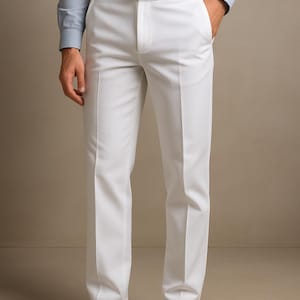 May include: White dress pants with a matching white belt. The pants have a classic, tailored fit. The outfit is completed with a light blue dress shirt and black leather dress shoes.