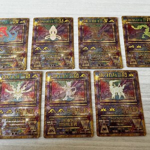 May include: Set of ten gold foil Pokemon cards featuring various Pokemon characters. The cards have a holographic finish and are in excellent condition.