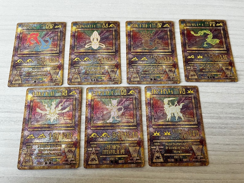 May include: Set of ten gold foil Pokemon cards featuring various Pokemon characters. The cards have a holographic finish and are in excellent condition.