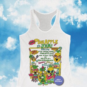May include: White tank top with a colorful graphic of pineapples playing musical instruments. The graphic says "Pineapple Jam!" and includes the text "Recipe: Pick fresh, juicy pineapples. Add a full set of musical instruments. Shake! Rattle & Roll!"