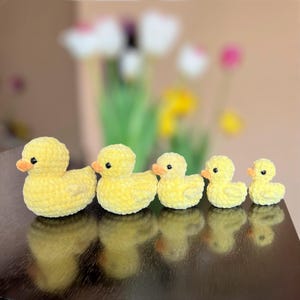 May include: A set of three ceramic mugs with a speckled, matte finish. The mugs are in shades of cream, light gray, and dark gray. Each mug has a simple, minimalist design, perfect for coffee or tea.