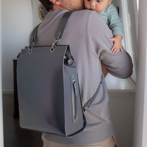 Best medium size leather backpack for trolley. Diaper bag with backpack straps and stroller hooks.