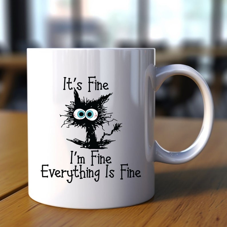 May include: White ceramic mug with a black cat illustration and the text "It's Fine I'm Fine Everything Is Fine".
