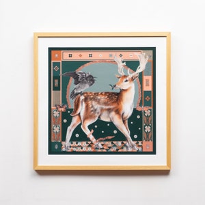 May include: A framed print of a stylized illustration of a deer with a bird perched on its back. The deer is brown and white with a green background and a patterned border. The bird is black and white.