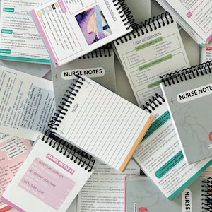 May include: A close-up of a stack of spiral bound notebooks with various medical information and instructions. The notebooks are labelled "Nurse Notes" and "Hands on Skills".