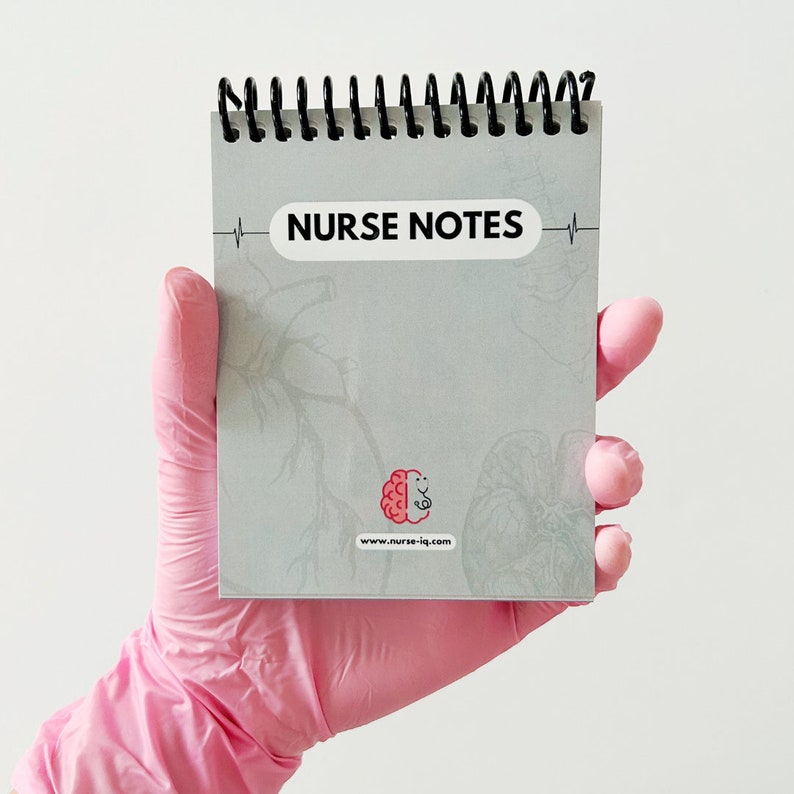 May include: A grey spiral notebook with the text "NURSE NOTES" on the front cover. The notebook has a brain and stethoscope logo and the website "www.nurse-iq.com" printed on the front cover.