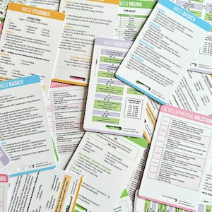 May include: A close-up of a stack of colorful flashcards with information about neonatal intensive care unit (NICU) basics, developmental milestones, pain scales, and feeding guidelines. The cards are printed with bold text and illustrations.