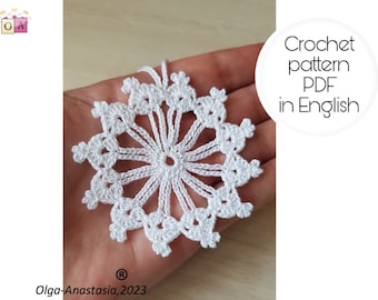 May include: White crochet snowflake ornament pattern in PDF format, written in English. The pattern is available for download.