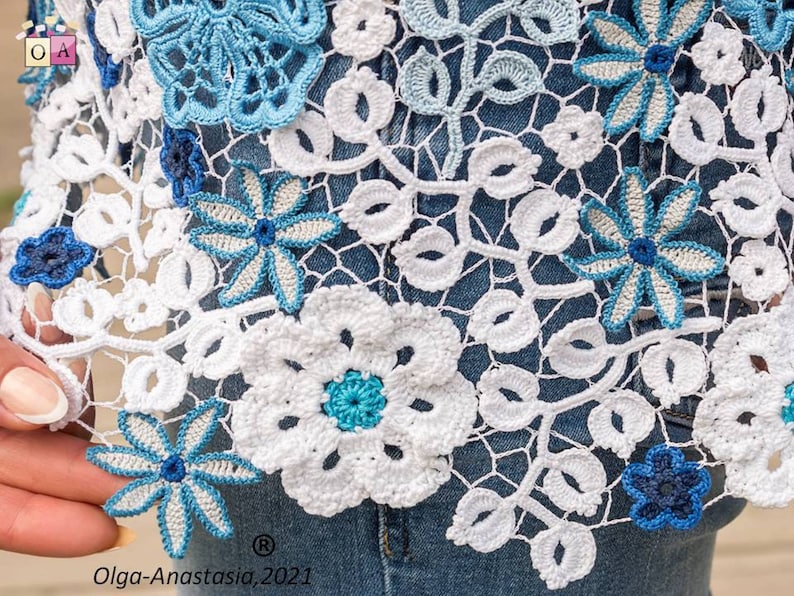 May include: White crochet lace with blue floral details. The lace is delicate and intricate, with a variety of different flower shapes and sizes. The lace is perfect for adding a touch of elegance to any project.