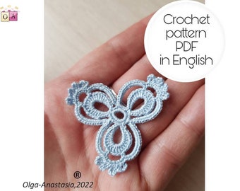May include: A light blue crochet pattern in the shape of a flower with three petals. The pattern is held in a hand. The text "Crochet pattern PDF in English" is written in a white circle above the pattern.