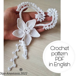 May include: White crochet flower with a stem and a long chain of beads. Crochet pattern PDF in English. Olga-Anastasia, 2022.