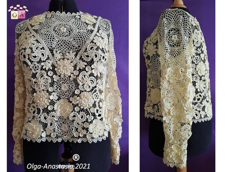 May include: A white crocheted top with a delicate floral design. The top has long sleeves and a round neckline. The top is made with intricate crochet stitches and features a variety of floral motifs.