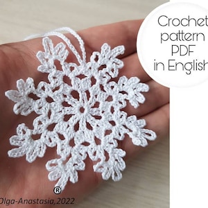 May include: White crochet snowflake ornament with a loop for hanging. Crochet pattern PDF in English.