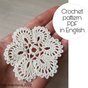 May include: A white crochet doily with a delicate floral design. Crochet pattern PDF in English.