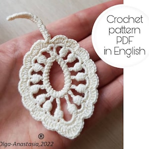 May include: A white crochet leaf pattern in PDF format, available in English. The pattern is shown on a hand, with the text "Crochet pattern PDF in English" and "Olga-Anastasia, 2022" visible.