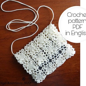 May include: White crochet bag with a long strap. The bag is made with a delicate lace pattern. The text "Crochet pattern PDF in English" is written in a white circle on a white background.