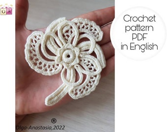 May include: A white crochet flower pattern in PDF format, available in English. The pattern is designed by Olga-Anastasia, 2022.