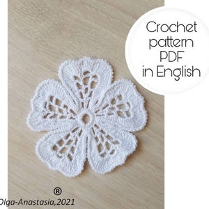 May include: White crochet flower pattern in PDF format, available in English. The pattern is for a delicate, lacy flower with a center hole.