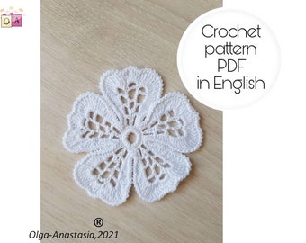May include: White crochet flower pattern in PDF format, available in English. The pattern is for a delicate, lacy flower with a center hole.