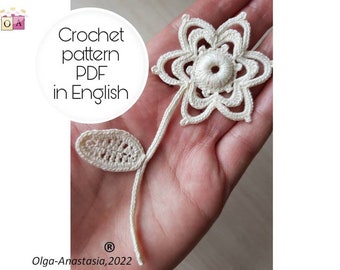 May include: A crochet flower pattern in PDF format, written in English. The flower is white and has a delicate design. The pattern includes a leaf.