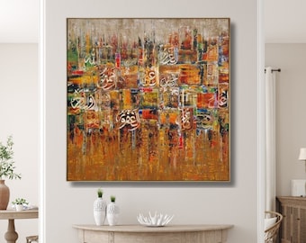 May include: Abstract painting with colorful geometric shapes and Arabic calligraphy in gold, red, green, blue, and white. The painting is framed in a gold frame and hangs on a white wall.