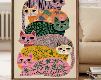 May include: A framed vertical art print featuring a stack of six stylized cats. The cats are depicted in various colors including purple, orange, green, pink, and yellow, each decorated with distinct floral, leaf, and striped patterns.