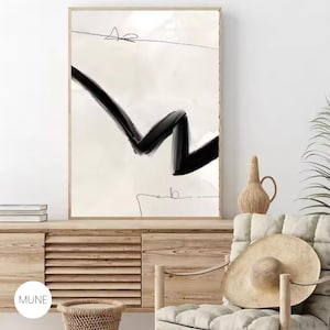 May include: A black and white abstract art print with a thick black line in a zig-zag pattern on a white background. The print is framed in a thin, light wood frame.